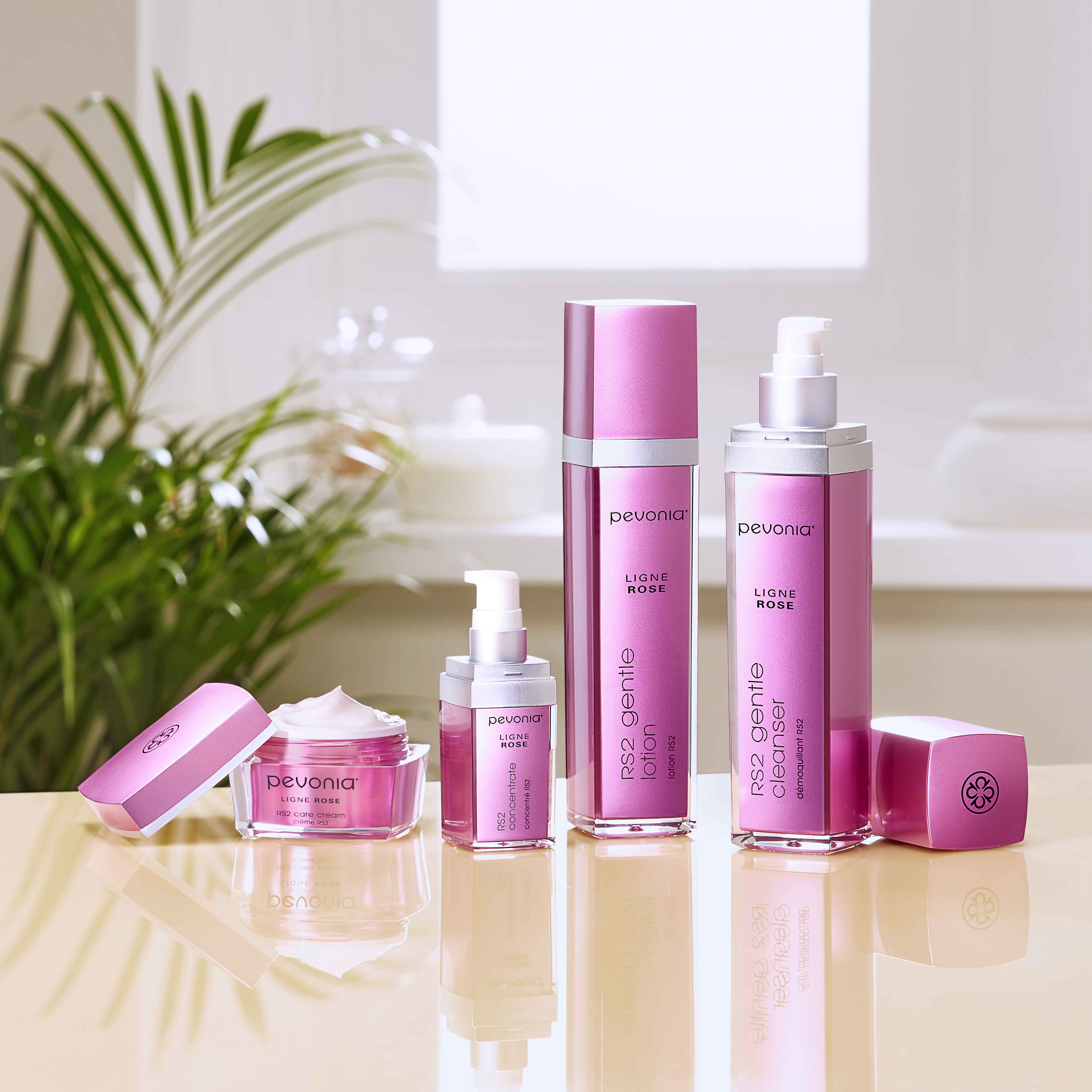 RS2 product lineup on a reflective table in front of a plant.