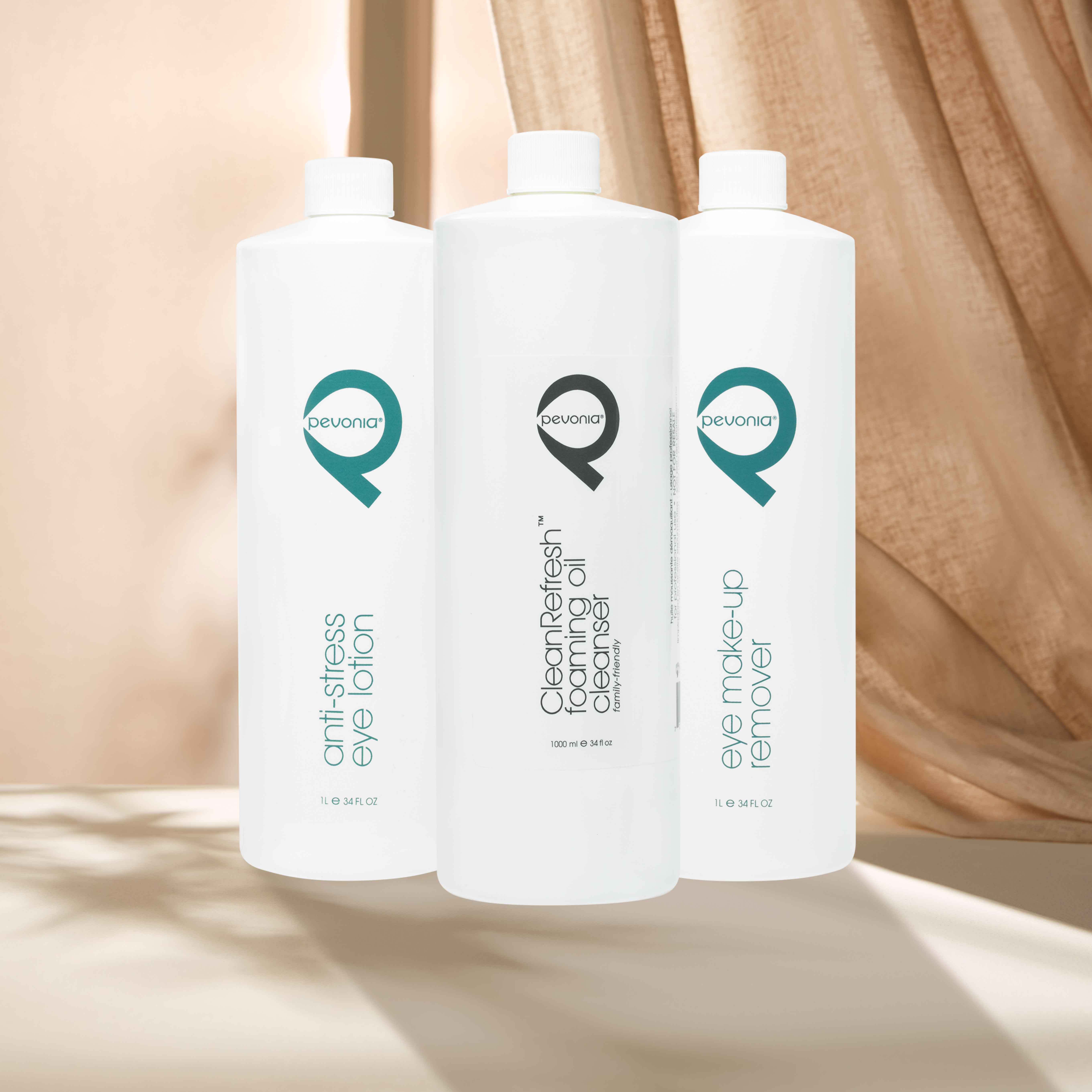 1000ml Pevonia Professional bottles aligned in front of curtains.