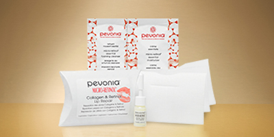 Pevonia's Retinol & Collagen Lip Repair on a reflective light brown surface.