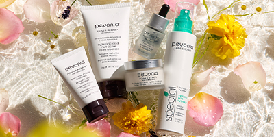 Pevonia Hyaluronic Acid products lying in water with rose petals.