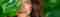 Brunette Woman Peeking out of Tropical Leaves