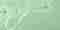 A light green background with a serum texture spilled on top.
